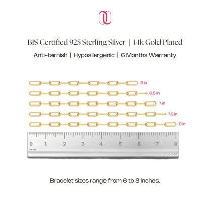 Gold chain bracelet with measurements and a ruler on a white background