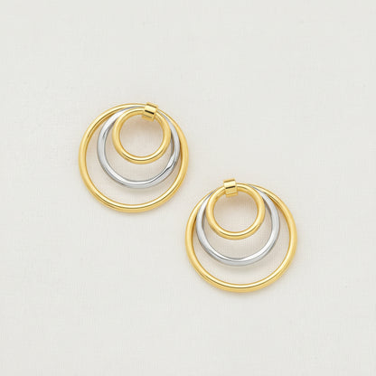 Dual-tone gold and rhodium circular dangler earrings in 925 silver, bold yet elegant — flat lay shot.