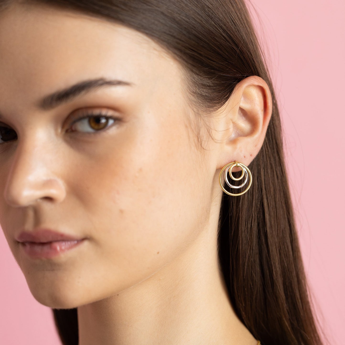 Dual-tone gold and rhodium circular dangler earrings in 925 silver, bold yet elegant — model - close-up shot.