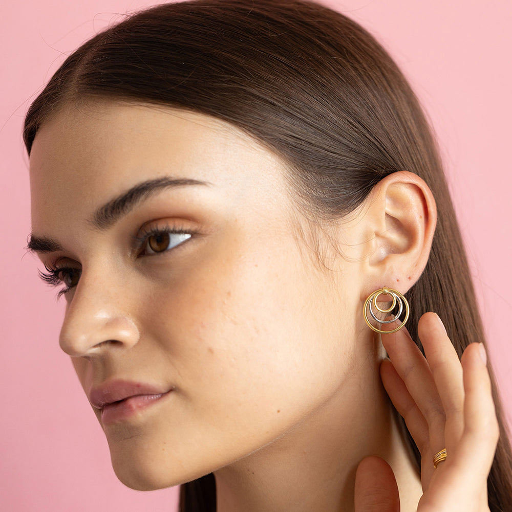 Dual-tone gold and rhodium circular dangler earrings in 925 silver, bold yet elegant — model - full look shot.