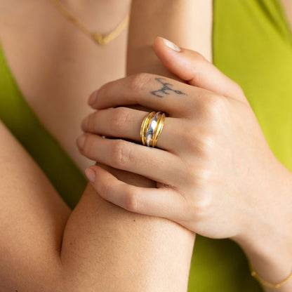 Dual-tone gold and rhodium signet band ring in 925 silver, bold everyday luxury — model - close-up shot.