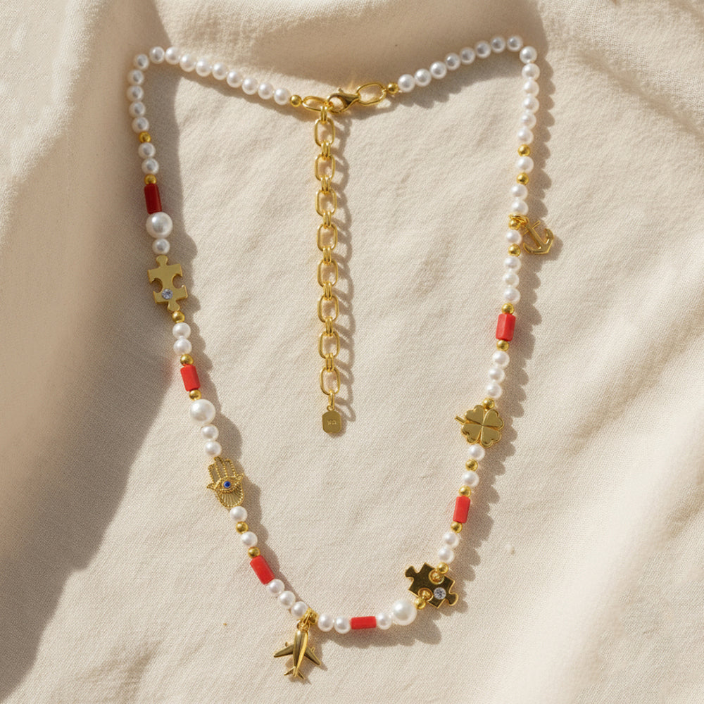 Gold-plated 925 silver necklace from the Enishi collection, colourful and modern — flat lay shot.