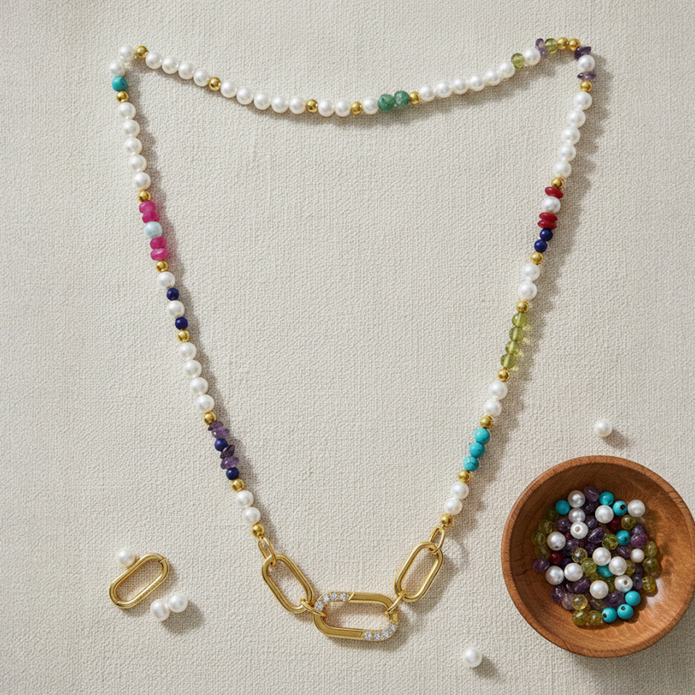 Gold-plated 925 silver necklace from the Enishi collection, colourful and modern — flat lay shot.