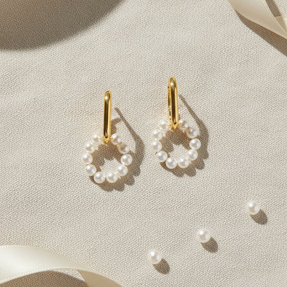 Gold-plated 925 silver earrings from the Enishi collection, designed for everyday friendship-inspired style — flat lay shot.