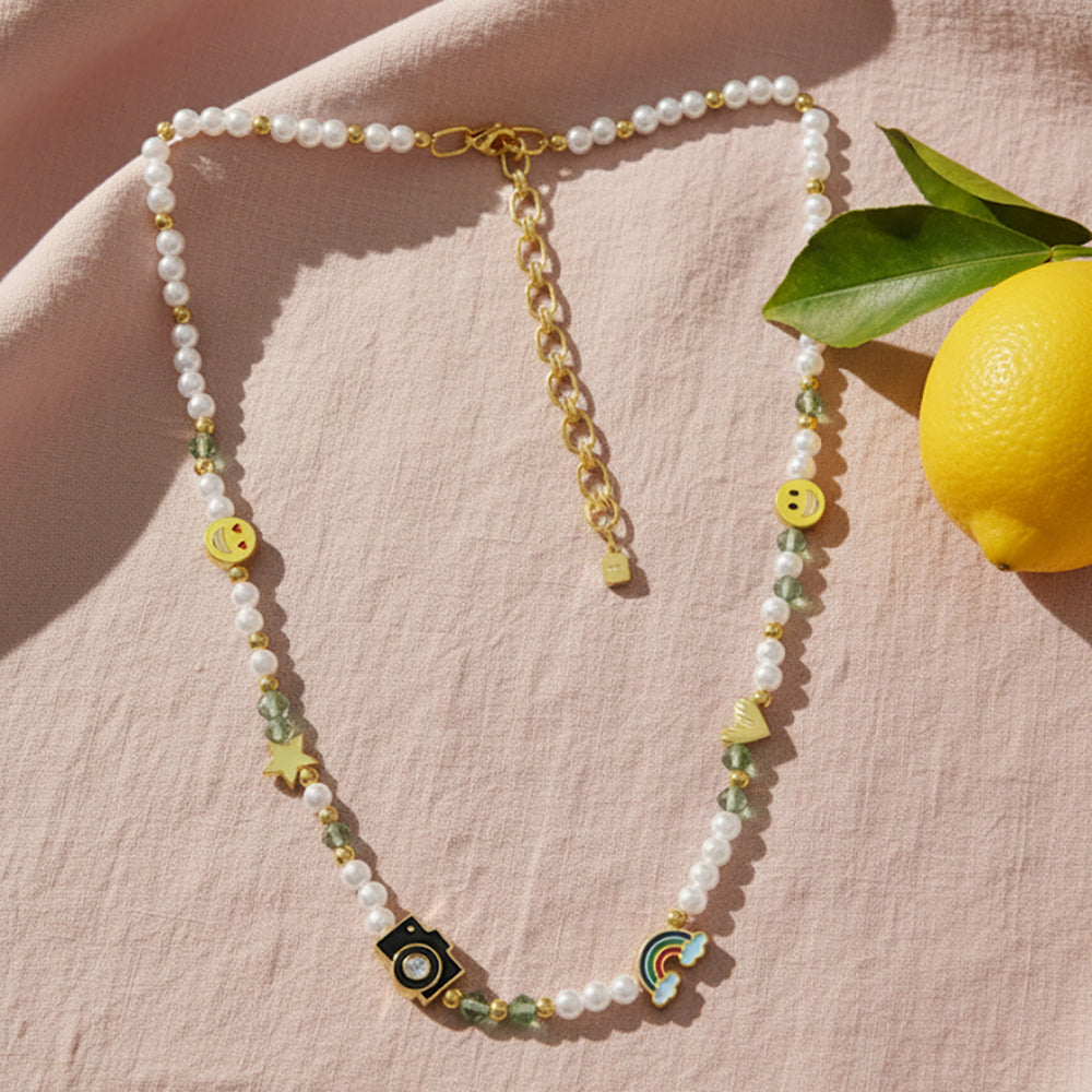 Gold-plated 925 silver necklace from the Enishi collection, colourful and modern — flat lay shot.