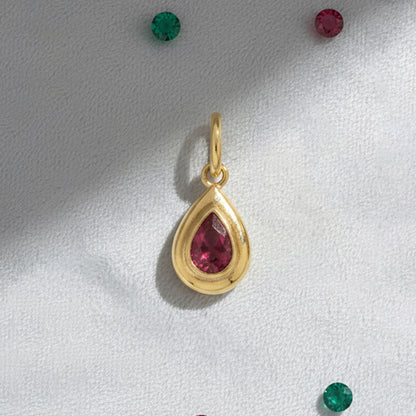 Flat Lay of KiraKira Ruby Charm | 925 Silver Gold-Plated from Nishani’s Kira Kira festive collection — handcrafted ruby jewelry, charm in gold-plated 925 silver.