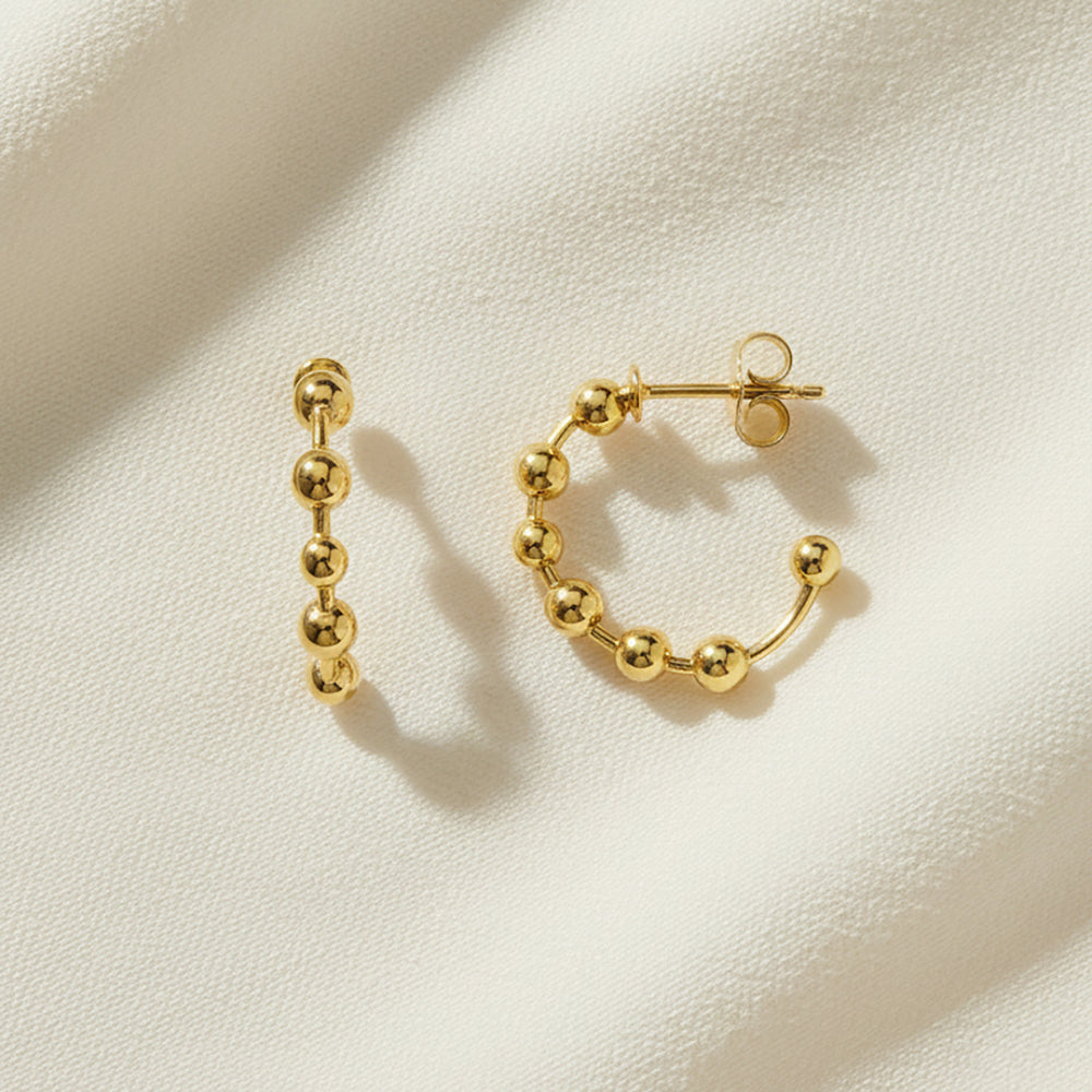 Flat Lay of Ukiyo Ball Hoops — a minimal, gold-plated 925 silver design crafted for everyday wear from Nishani’s Ukiyo collection.