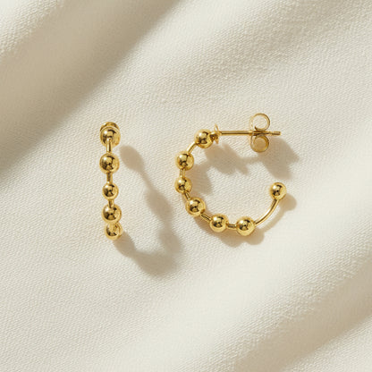 Flat Lay of Ukiyo Ball Hoops — a minimal, gold-plated 925 silver design crafted for everyday wear from Nishani’s Ukiyo collection.
