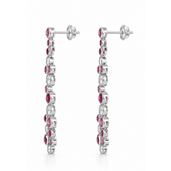 A pair of silver-toned drop earrings featuring a vertical line of round-cut pink gemstones and clear stones, shown against a plain white background.