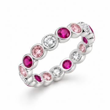 A silver eternity band ring featuring alternating round pink gemstones and clear round-cut stones, shown on a clean white background.