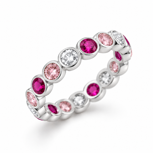 A silver eternity band ring featuring alternating round pink gemstones and clear round-cut stones, shown on a clean white background.