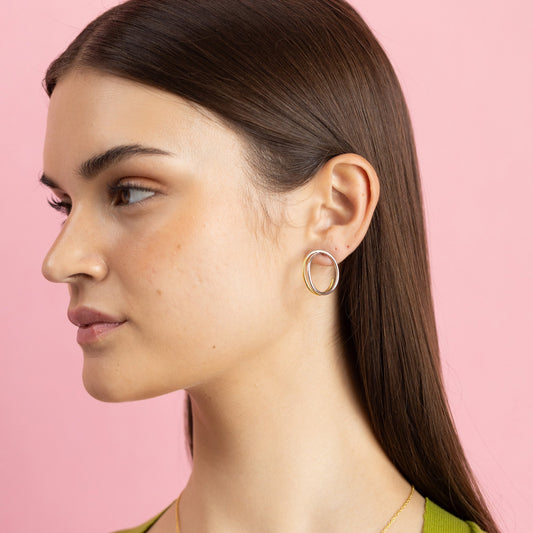 Gold and rhodium intertwined stud earrings in 925 silver, modern dual-tone design — model - full look shot.