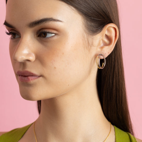Gold and rhodium intertwined stud earrings in 925 silver, modern dual-tone design — model - full look shot.