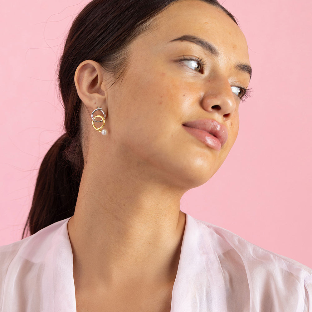 Gold and rhodium knot-a-pearl earrings in 925 silver, bold dual-tone pearl design — model - full look shot.