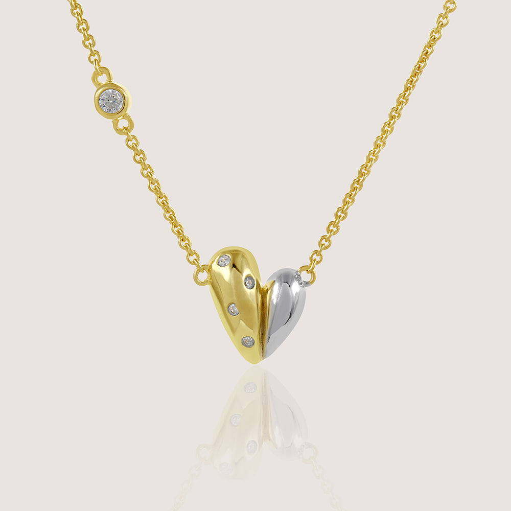 Gold and rhodium organic heart necklace in 925 silver, statement sculptural pendant — product - close up shot.