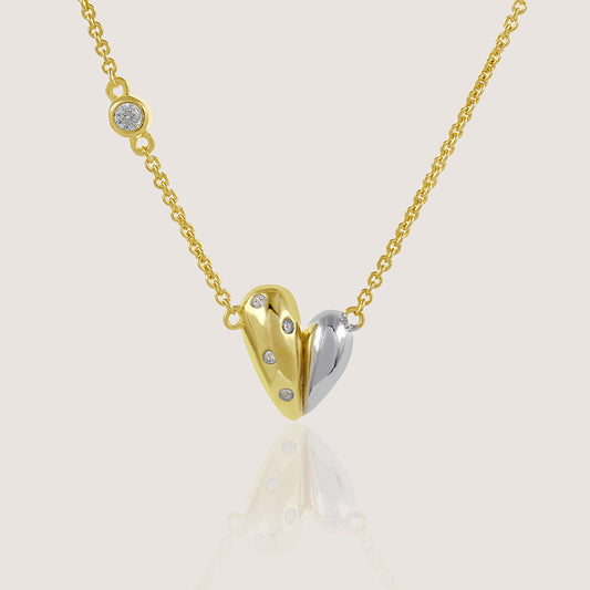 Gold and rhodium organic heart necklace in 925 silver, statement sculptural pendant — product - close up shot.