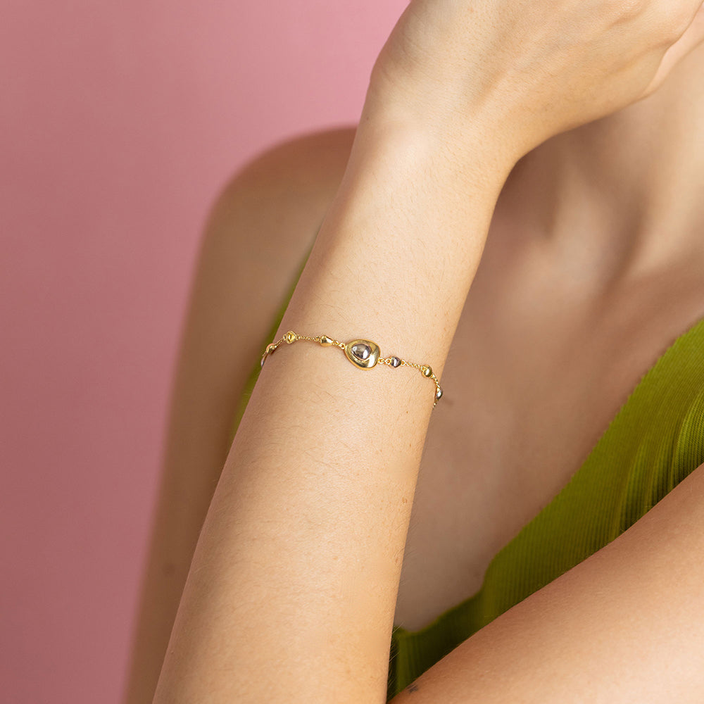 Gold and rhodium puffed bracelet in 925 silver, statement dual-tone wristwear — model - close-up shot.