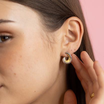 Gold and rhodium scooped studs in 925 silver, sculptural design for bold elegance — model - close-up shot.