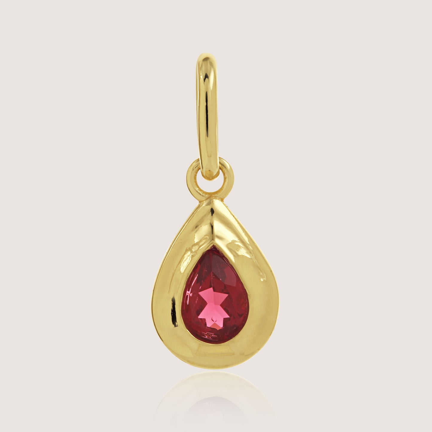 White Background - Front of KiraKira Ruby Charm 925 Silver Gold-Plated from Nishani’s Kira Kira festive collection handcrafted ruby jewelry, charm in gold-plated 925 silver.
