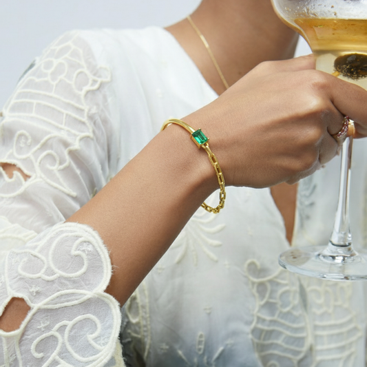 Model Image 1 of KiraKira Emerald Cuff | 925 Silver Gold-Plated from Nishani’s Kira Kira festive collection — handcrafted emerald jewelry, bracelet in gold-plated 925 silver.