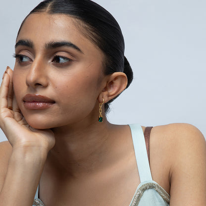 Model Image 1 of KiraKira Emerald Danglers | 925 Silver Gold-Plated from Nishani’s Kira Kira festive collection — handcrafted emerald jewelry, earrings in gold-plated 925 silver.