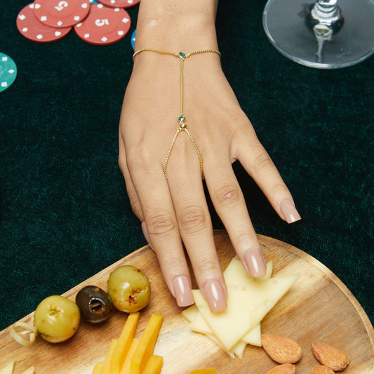 Model Image 1 of KiraKira Emerald Hand Chain | 925 Silver Gold-Plated from Nishani’s Kira Kira festive collection — handcrafted emerald jewelry, bracelet in gold-plated 925 silver.