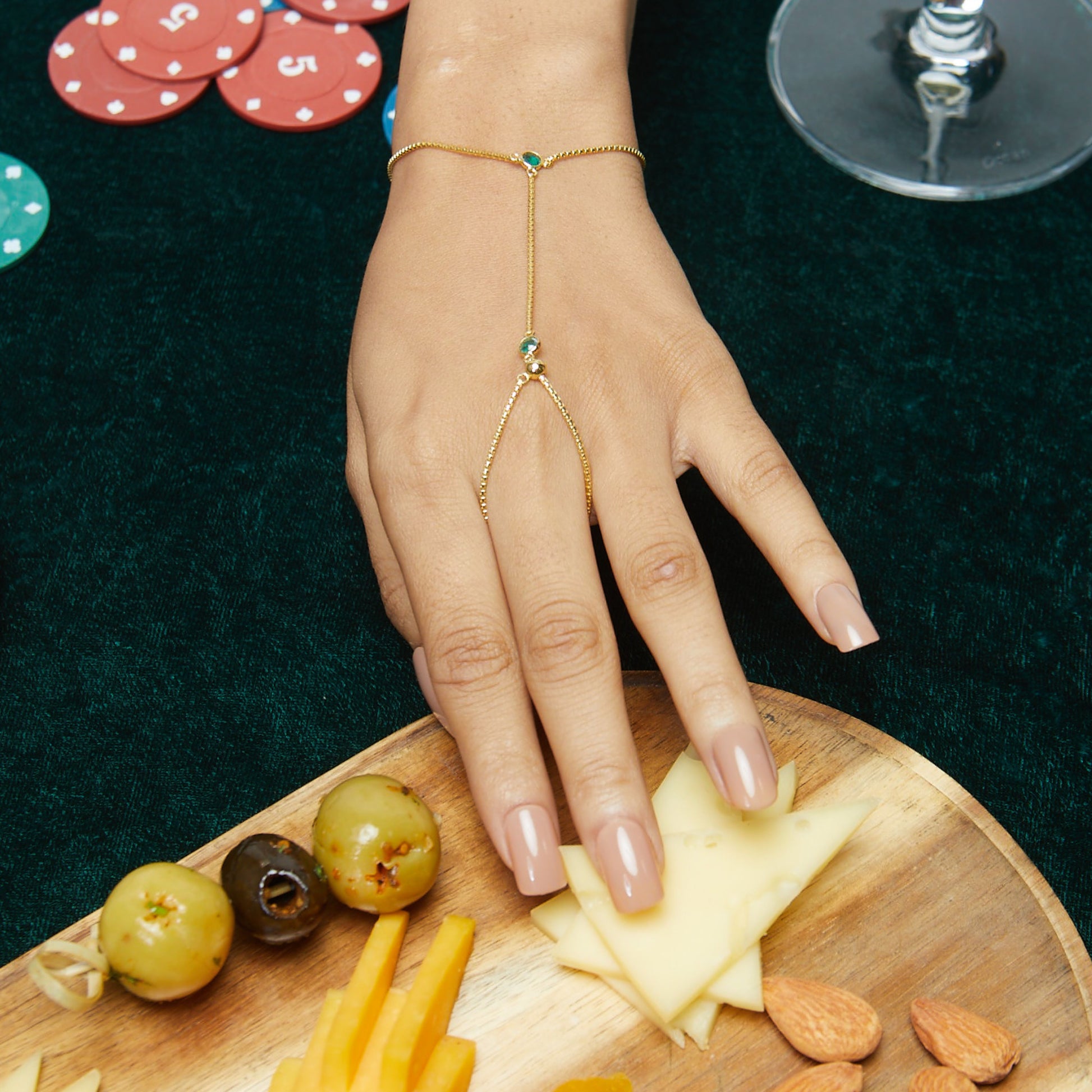 Model Image 1 of KiraKira Emerald Hand Chain | 925 Silver Gold-Plated from Nishani’s Kira Kira festive collection — handcrafted emerald jewelry, bracelet in gold-plated 925 silver.