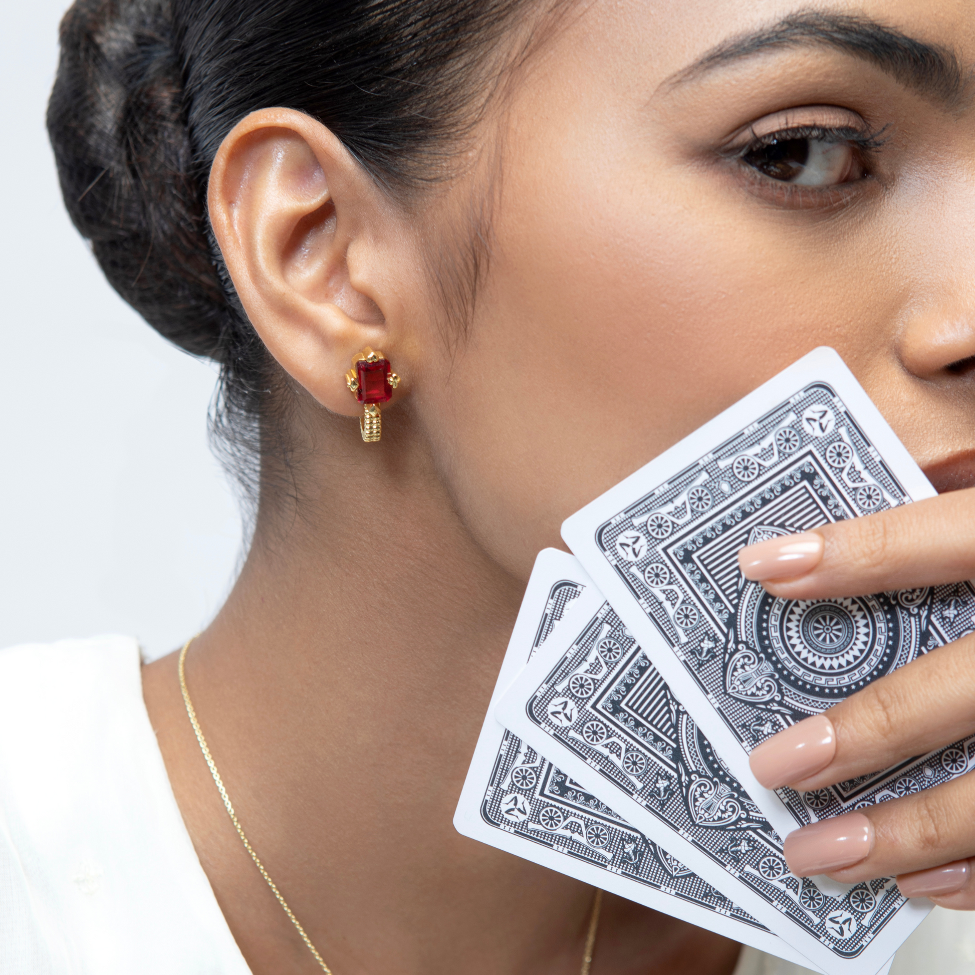 Model Image 1 of KiraKira Suits Stud Earrings | 925 Silver Gold-Plated from Nishani’s Kira Kira festive collection — handcrafted earrings in gold-plated 925 silver.