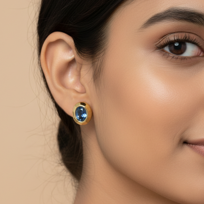 Model Image 1 of KiraKira Sapphire Stud Earrings | 925 Silver Gold-Plated from Nishani’s Kira Kira festive collection — handcrafted sapphire jewelry, earrings in gold-plated 925 silver.