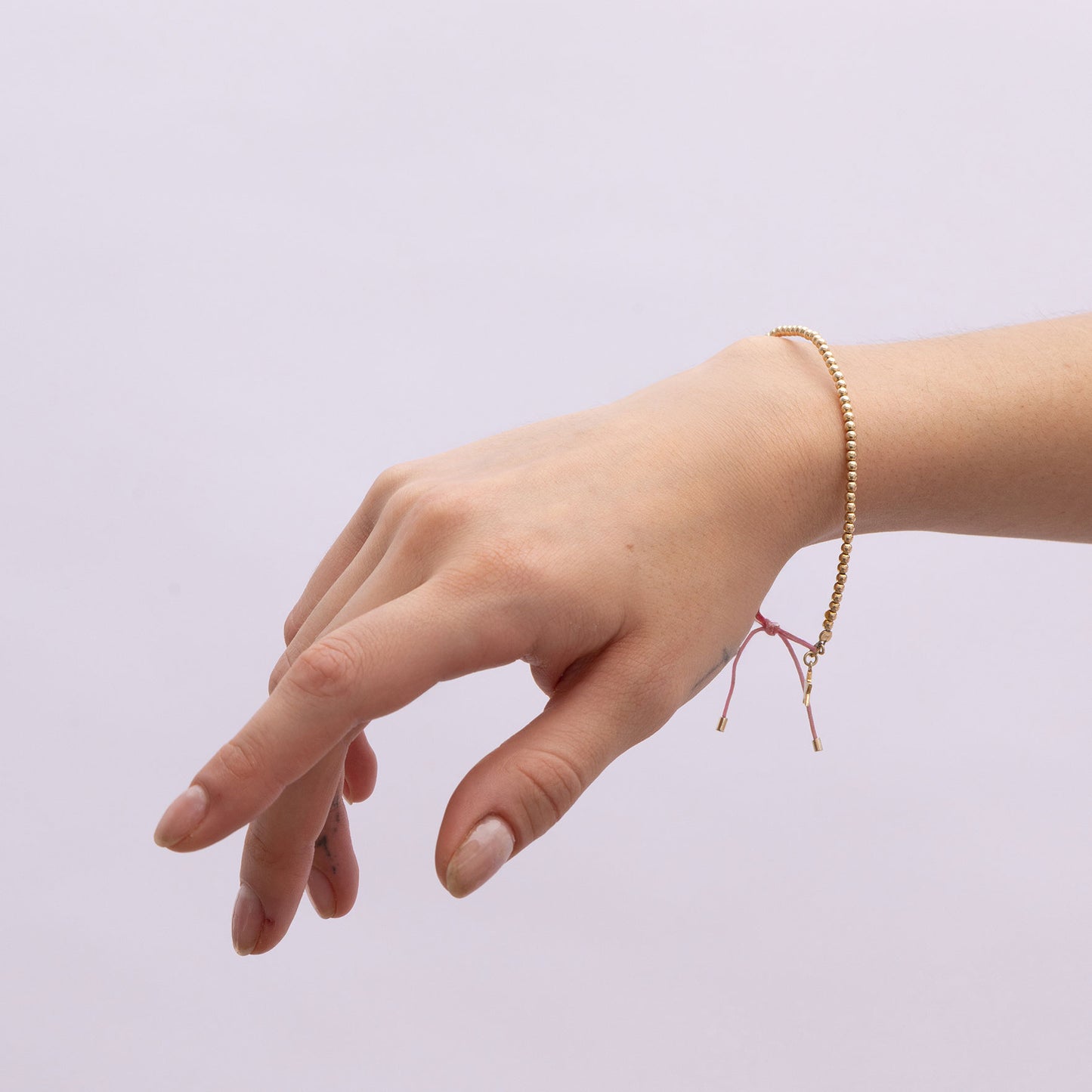 Model Image 1 of Ukiyo Beaded Thread Bracelet — a minimal, gold-plated 925 silver design crafted for everyday wear from Nishani’s Ukiyo collection.