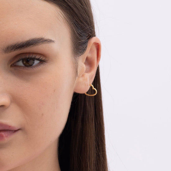 Model Image 1 of Ukiyo Mini Heart Huggies — a minimal, gold-plated 925 silver design crafted for everyday wear from Nishani’s Ukiyo collection.
