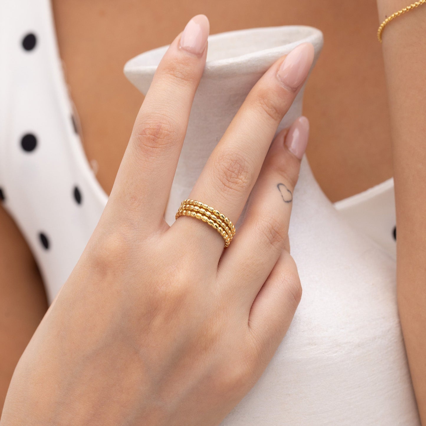 Model Image 1 of Ukiyo Trio Ball Rings — a minimal, gold-plated 925 silver design crafted for everyday wear from Nishani’s Ukiyo collection.