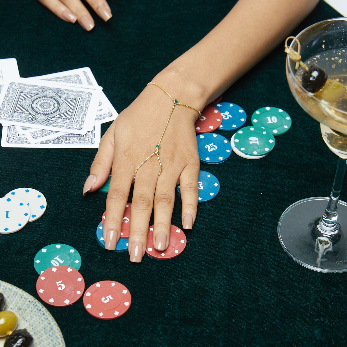 Model Image 2 of KiraKira Emerald Hand Chain | 925 Silver Gold-Plated from Nishani’s Kira Kira festive collection — handcrafted emerald jewelry, bracelet in gold-plated 925 silver.