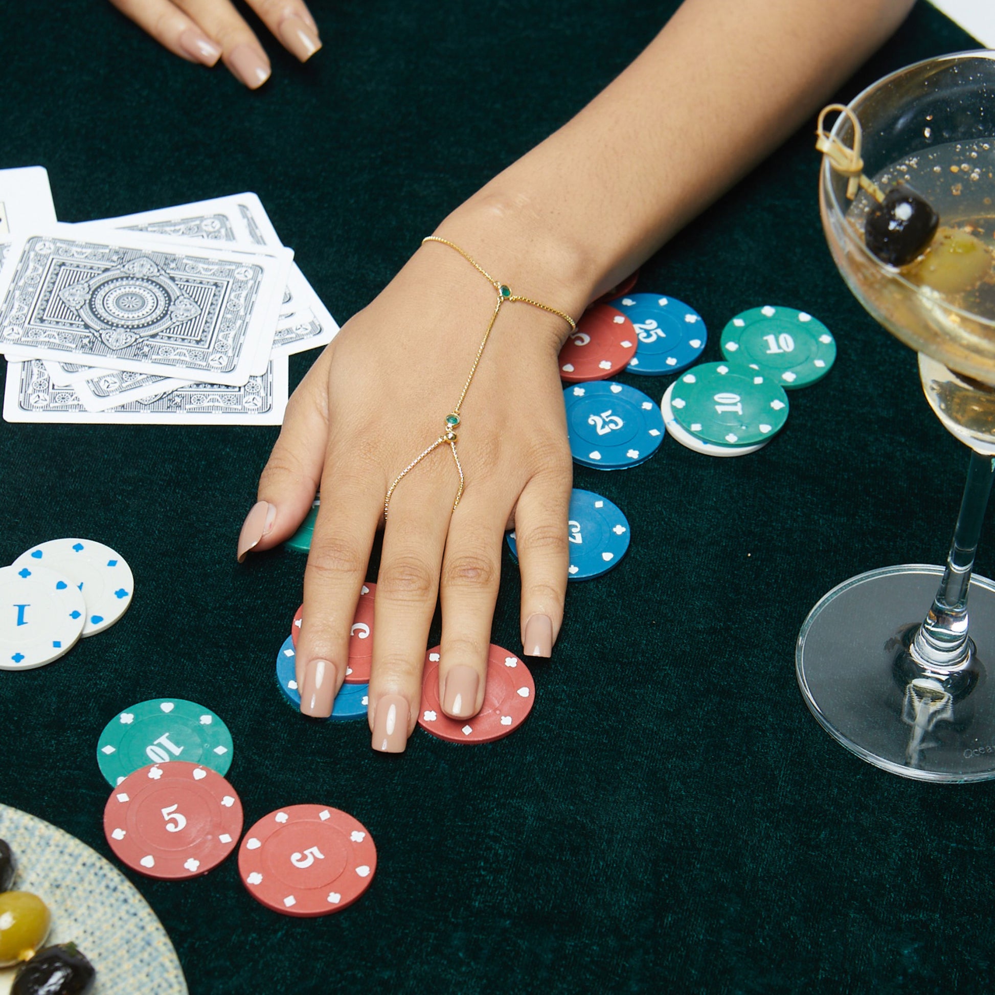 Model Image 2 of KiraKira Emerald Hand Chain | 925 Silver Gold-Plated from Nishani’s Kira Kira festive collection — handcrafted emerald jewelry, bracelet in gold-plated 925 silver.