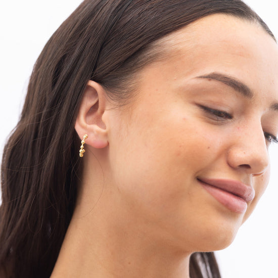 Model Image 1 of Ukiyo Ball Hoops — a minimal, gold-plated 925 silver design crafted for everyday wear from Nishani’s Ukiyo collection.