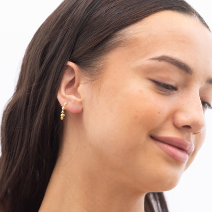 Model Image 1 of Ukiyo Ball Hoops — a minimal, gold-plated 925 silver design crafted for everyday wear from Nishani’s Ukiyo collection.