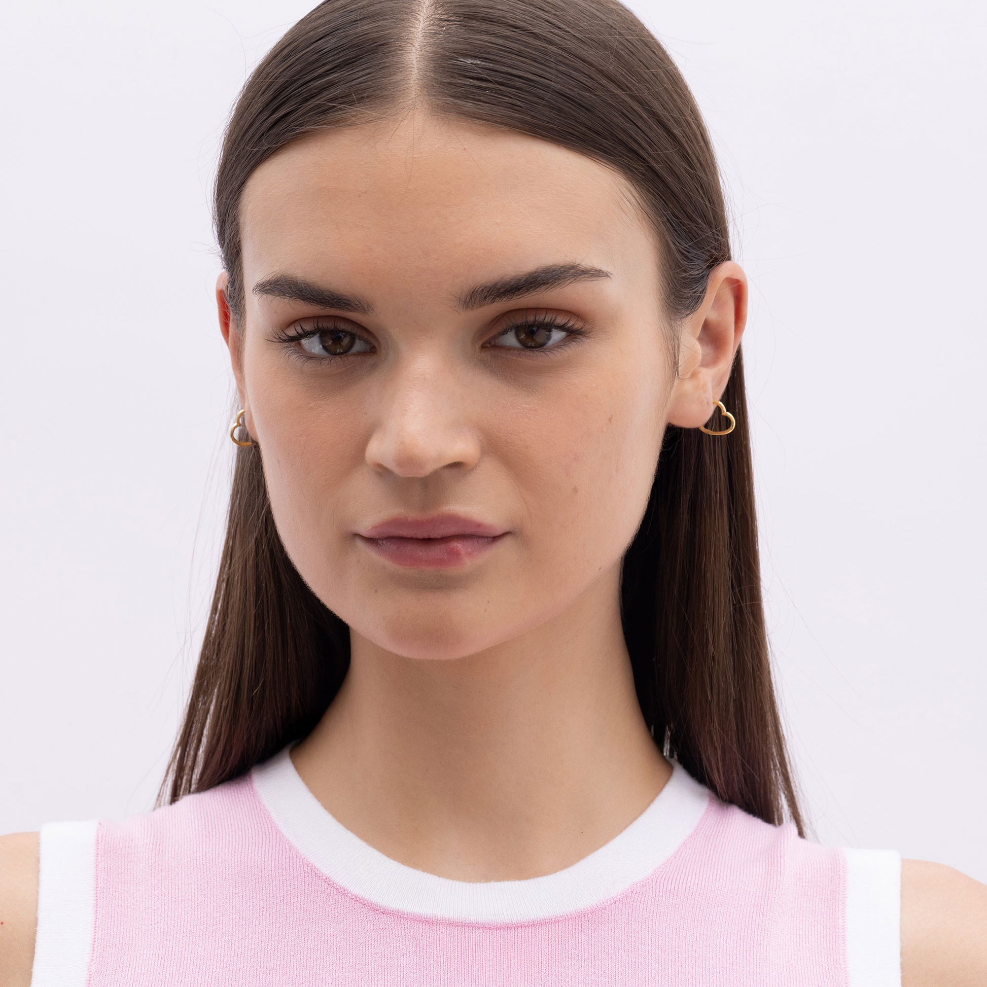 Model Image 2 of Ukiyo Mini Heart Huggies — a minimal, gold-plated 925 silver design crafted for everyday wear from Nishani’s Ukiyo collection.