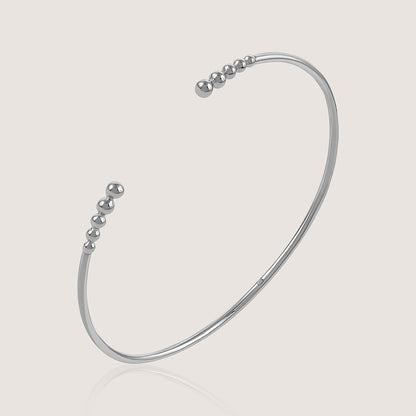 Ukiyo Open Bangle — a minimal, rhodium-plated 925 silver design crafted for everyday wear from Nishani’s Ukiyo collection.