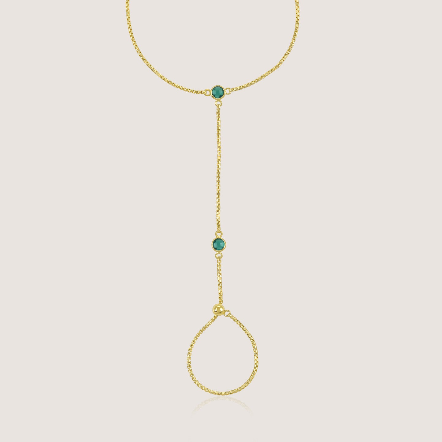 White Background - Close-up of KiraKira Emerald Hand Chain | 925 Silver Gold-Plated from Nishani’s Kira Kira festive collection — handcrafted emerald jewelry, bracelet in gold-plated 925 silver.