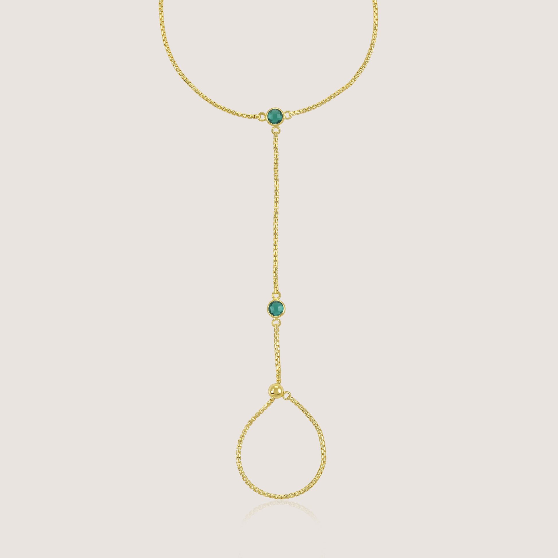 White Background - Close-up of KiraKira Emerald Hand Chain | 925 Silver Gold-Plated from Nishani’s Kira Kira festive collection — handcrafted emerald jewelry, bracelet in gold-plated 925 silver.