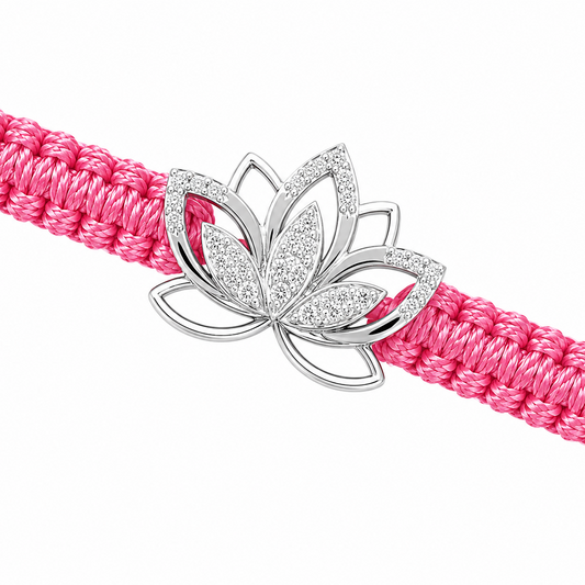 A pink braided cord bracelet with a silver lotus flower charm embellished with clear crystals, shown on a plain white background.