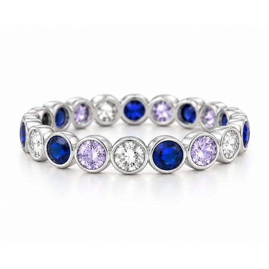A silver-toned eternity bracelet featuring alternating round-cut deep blue sapphires and light purple amethysts, with clear round-cut diamonds in the center of each bezel, set against a seamless white background.